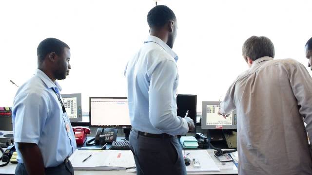 Air traffic controllers at the Vance W. Amory International Airport Air Traffic Control Tower, in training for newly installed Voice Command and Control System with Aeronav Inc. technician